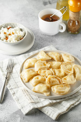 Dumplings, filled with cottage cheese. Russian, Ukrainian or Polish dish varenyky, vareniki, pierogi, pyrohy.
