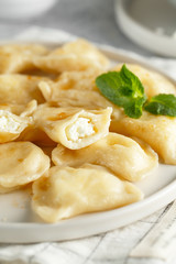 Dumplings, filled with cottage cheese. Russian, Ukrainian or Polish dish: varenyky, vareniki, pierogi, pyrohy.