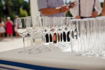 Champagne glass with dining set prepare dinner on table by the swimming pool
