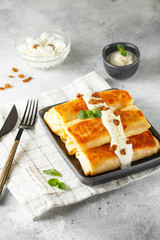 Russian thin pancakes with cottage cheese and raisins. Healthy traditional breakfast