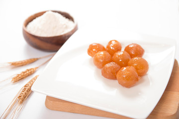 traditional bite dessert with wheat head on a white plate