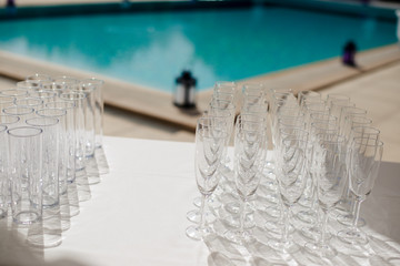 Champagne glass with dining set prepare dinner on table by the swimming pool