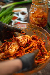 Preparing Kimchee with brightly colored ingredients. 