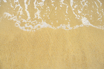 Soft wave of blue ocean on sandy beach. Background