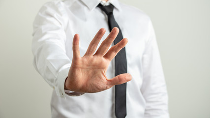 Businessman making a stop gesture with his hand