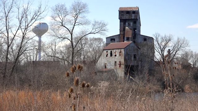 Very old abandoned rusting mill or factory suggests the end of America as an industrial power.