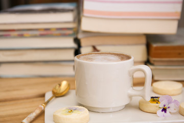 Obraz na płótnie Canvas cup of cafe latte and old books