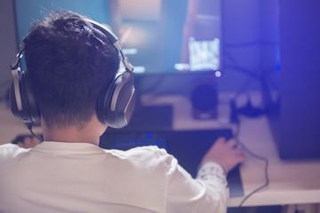 Portrait of asian boy gamer playing games on computer in the room at home © Koonsiri