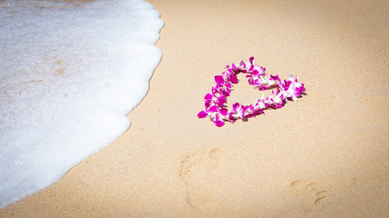 Orchid Lei on a Maui beach with soft surf
