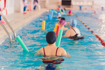 women trains in aqua aerobics, learn to swim.