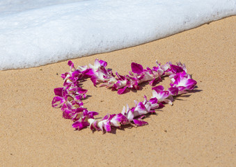 Orchid Lei on a Maui beach with soft surf