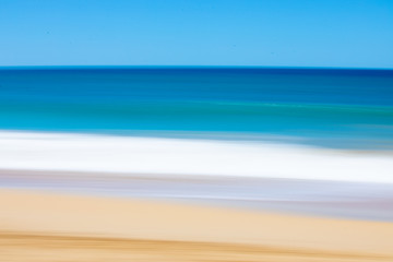 Fototapeta na wymiar Soft beach scene with motion blur