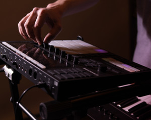Fototapeta na wymiar Musician playing drum pad synthesizer