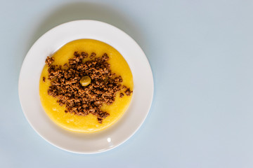 Polenta meal with ground beef, on white plate.