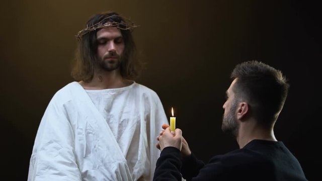 Christ leaving praying man, parishioner blowing out candle, presence of God