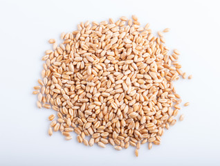 Heap of wheat grains isolated on white background.
