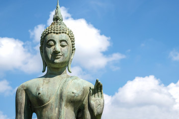 Fototapeta na wymiar Close up of Bronze Buddha statue with beautiful sky. Buddha is the lord of Buddhist religion.