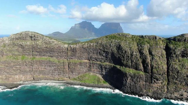 Aerial 4k drone footage of Lord Howe Island, a pacific subtropical island in the Tasman Sea, belonging to Australia. Malabar Hill & Ned's Beach in foreground, Mt Lidgbird & Mt Gower in background.