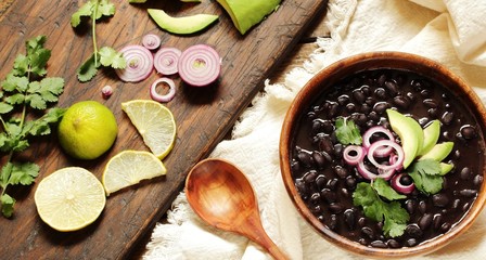 thick black bean soup or stew. Latin American or Mexican cuisine. stewed black beans served with...