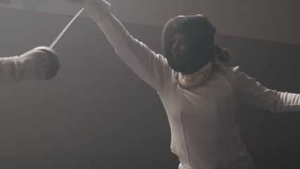 A female fencer attacks and parrying in a dark and dusty fencing gym - Powered by Adobe