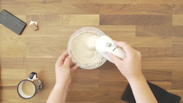 Women Making Gluten Free Bread. Mixing The Flour with handy mixer to make dough.