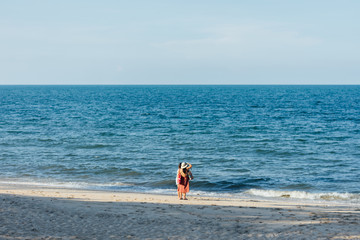 Two woman stand realx the sea