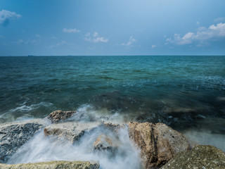 Ocean water rushing by a rock.