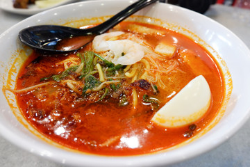 Curry soup seafood shrimp with coconut milk and vegetables herbal spices spicy in bowl / Malaysian food noodle soup