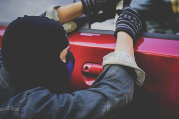 Gangster with a gun trying to rob car.