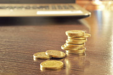 Heap of gold coins on a table in the room.