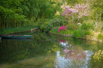 Giverny, France - 05 07 2019: The gardens of Claude Monet in Giverny. Bamboos, small boats and...