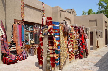 A traditional shop in the narrow streets of old Dubai with arabic carpets exposed. Al Bastakiya district is also known as Al Fahidi Historical Neighbourhood