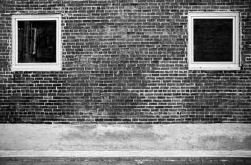 Brick wall with two square windows B&W
