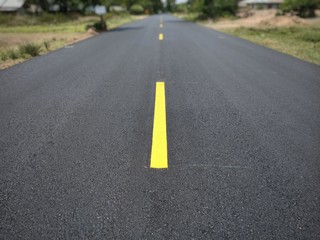 Fototapeta na wymiar Road traffic paint Yellow on the asphalt surface