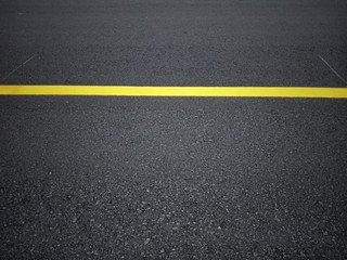 Road traffic paint Yellow on the asphalt surface