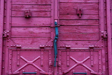Door lock mechanism on wooden red railway carriage close up shot.