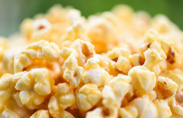 Close up popcorn in cup and nature green backgroubd - Sweet butter popcorn salt