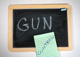 Gun control message on chalkboard and note pad