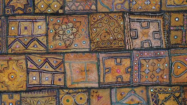 Detail old colorful patchwork carpet, establishing shot. Close up
