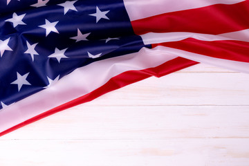 American flag on white wooden background for Memorial Day or 4th of July with copy space.