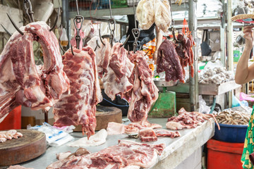 Meat hanging for sale in a Khmer butcher’s shop.