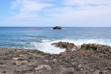 Ocean waves splashing against a rocky coast line