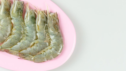 raw prawn on pink dish