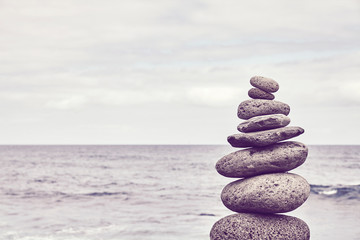 Pyramid made of stones on a beach, color toned picture.