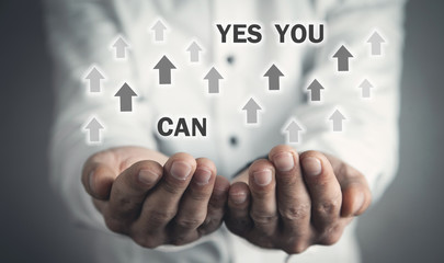Man holding Yes You Can text with arrows. Motivation, Business, Development