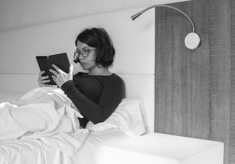 Black and white photo of woman reading an ebook