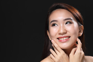 Young beautiful Asian woman makeup dark background 