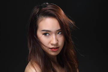Fototapeta premium Young beautiful Asian woman makeup dark background 