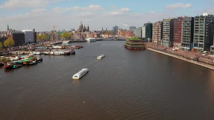 Beautiful aerial view of Amsterdam narrow canals with many boats