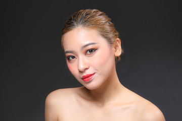 Young beautiful Asian woman makeup dark background 